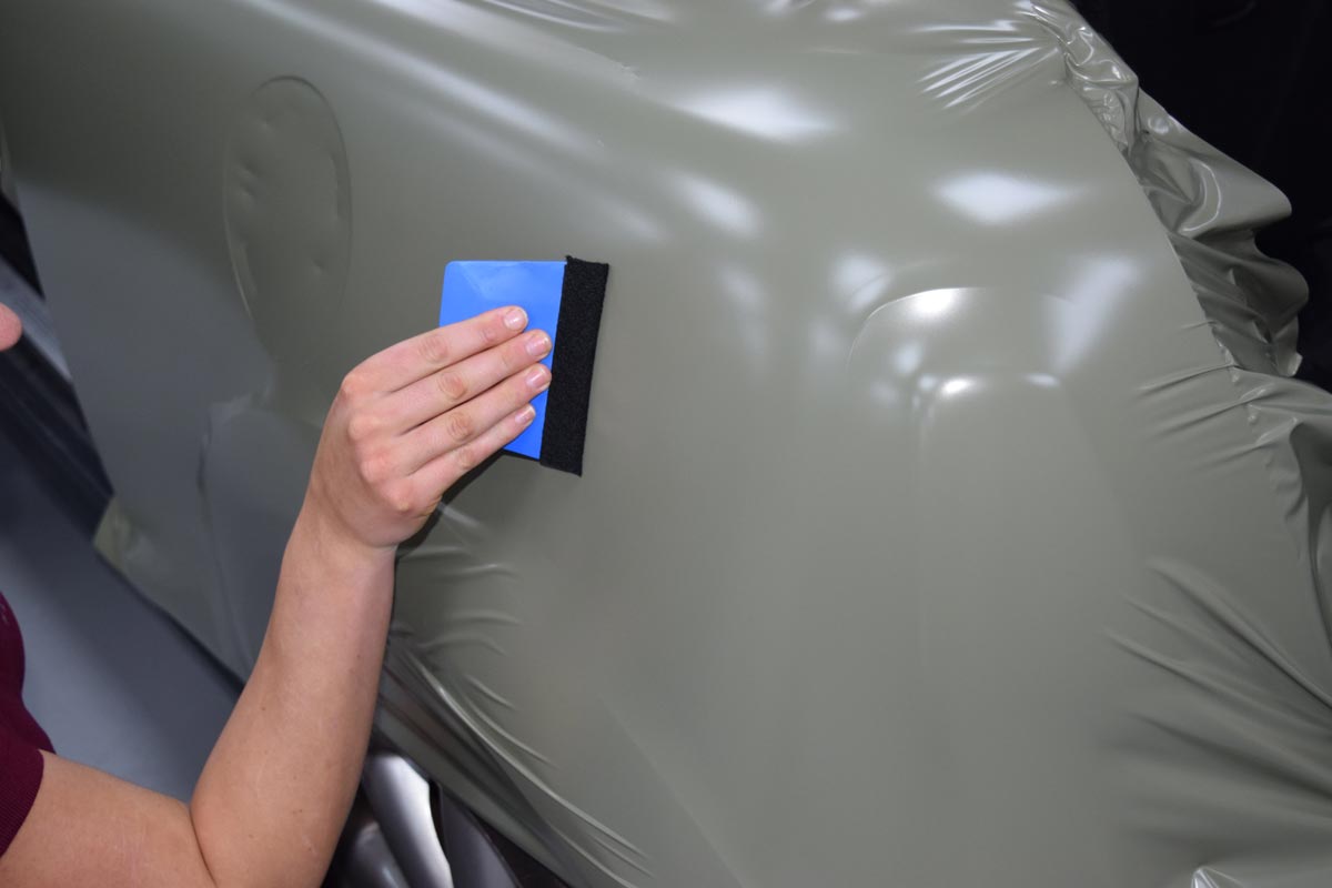 A Mini vehicle in the process of having a vinyl wrap applied